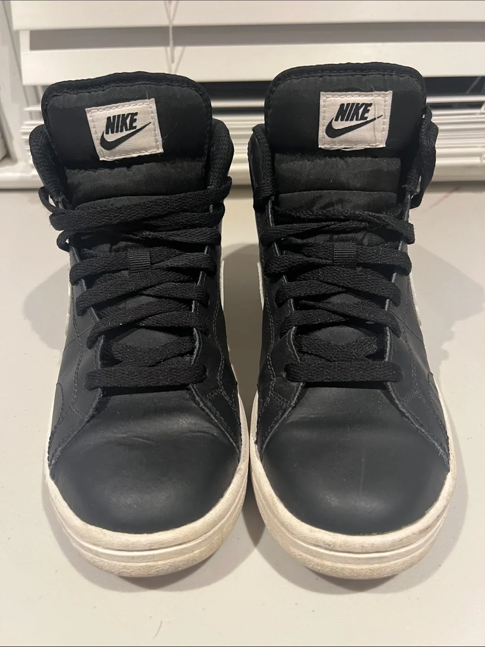 Nike Black High-Top Sneakers with White Soles and White Tongue Logo